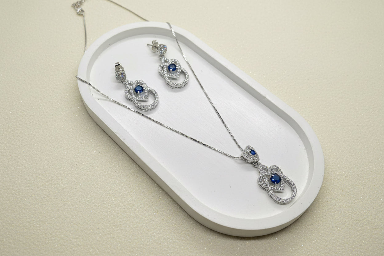 Silver blue diamond pendant and earring set.