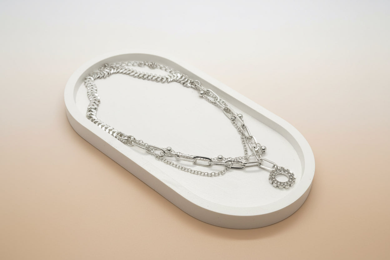 silver layered chain necklace with a rhinestone circle pendant